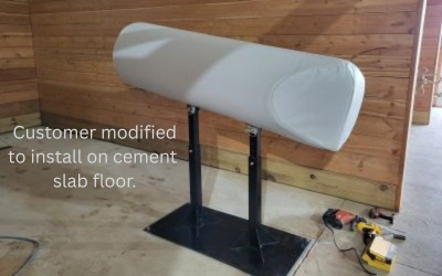 A gray SMS breeding phantom modified with a flat steel baseplate for anchoring directly into a concrete floor.